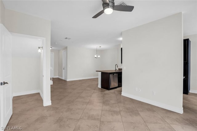 empty room with sink, ceiling fan with notable chandelier, and light tile patterned floors