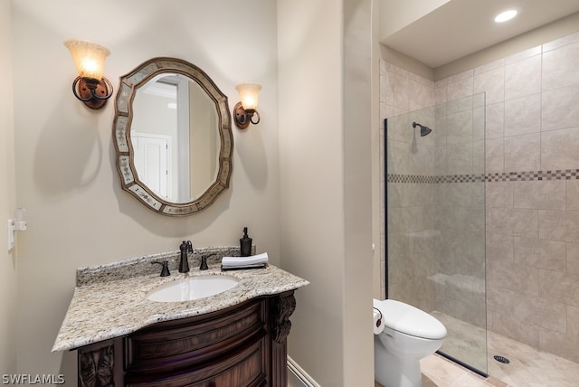 bathroom with toilet, vanity, and walk in shower