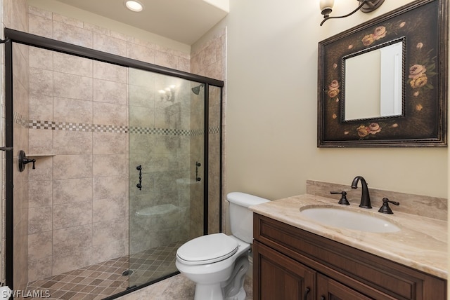 bathroom with an enclosed shower, vanity, and toilet