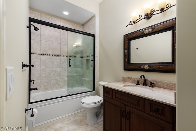 full bathroom featuring toilet, vanity, and shower / bath combination with glass door