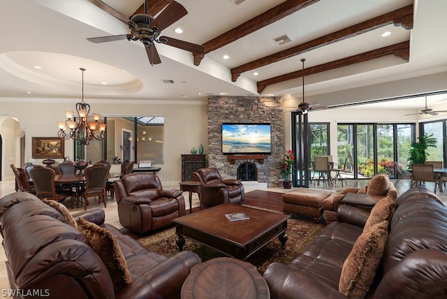 living room featuring a stone fireplace, ceiling fan with notable chandelier, ornamental molding, and beam ceiling