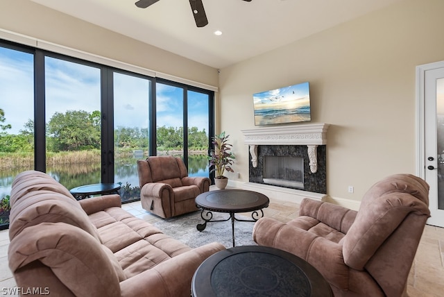 tiled living room with a premium fireplace and ceiling fan