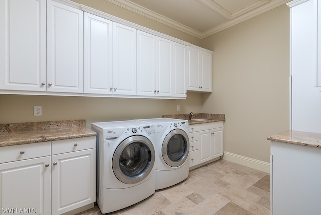 clothes washing area with washing machine and dryer, cabinets, sink, and ornamental molding