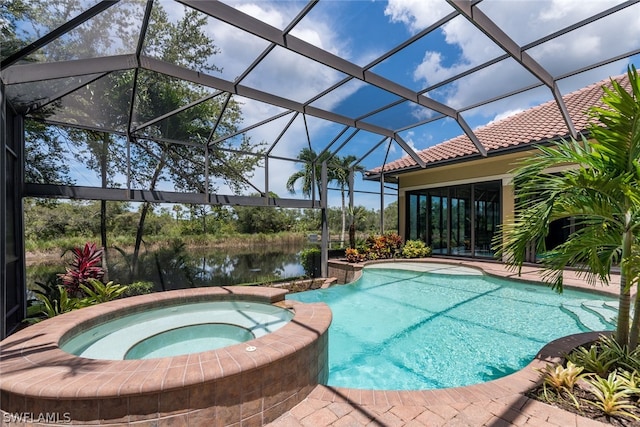 view of pool featuring a water view, glass enclosure, and an in ground hot tub