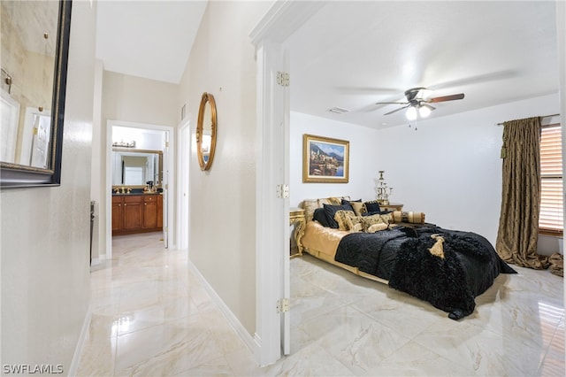 tiled bedroom featuring ensuite bath and ceiling fan