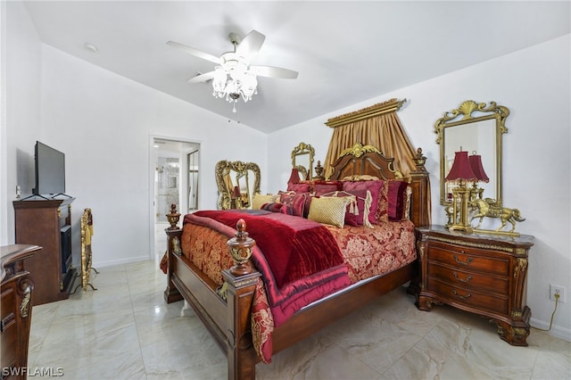 bedroom with connected bathroom, lofted ceiling, light tile patterned floors, and ceiling fan