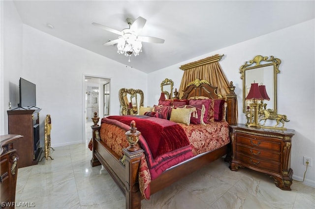 bedroom featuring vaulted ceiling, ceiling fan, ensuite bath, and baseboards