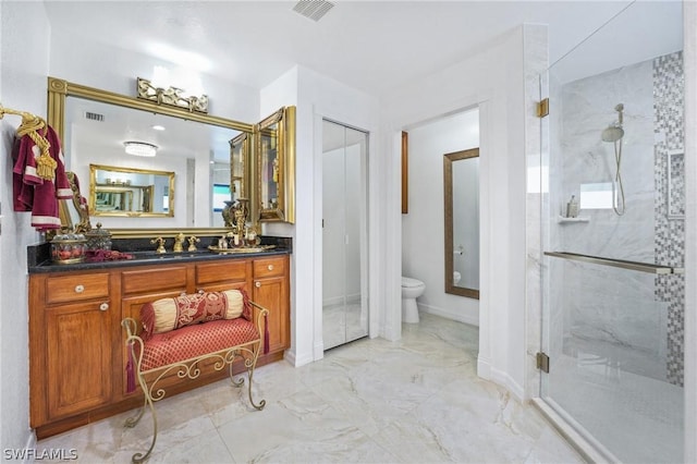 bathroom featuring a marble finish shower, visible vents, toilet, marble finish floor, and vanity