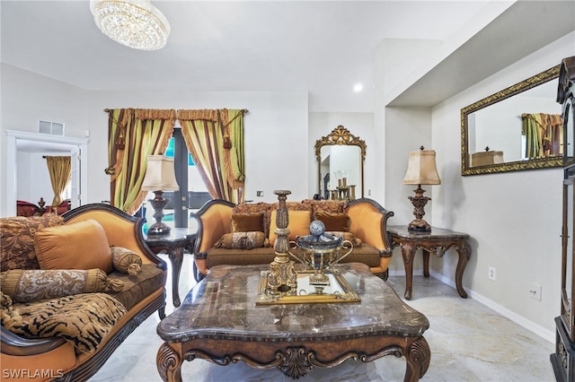 living room featuring light tile patterned flooring and an inviting chandelier