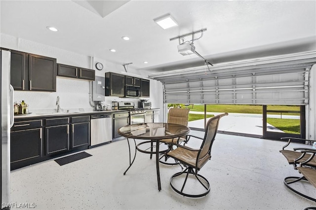 garage with recessed lighting, a sink, and a garage door opener