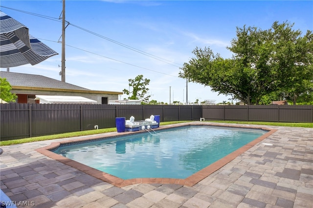 view of pool with a patio and pool water feature