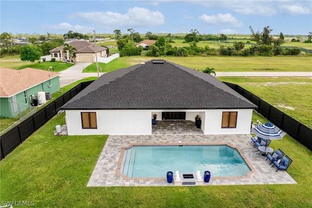 view of swimming pool featuring a lawn, a patio area, a fenced backyard, and a fenced in pool