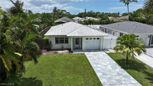 ranch-style home with a garage and a front yard