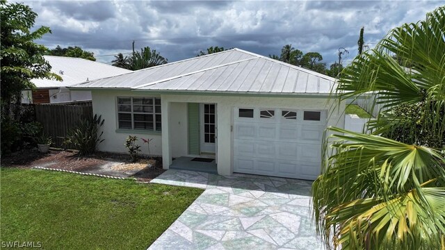 view of front of property featuring a garage and a front lawn