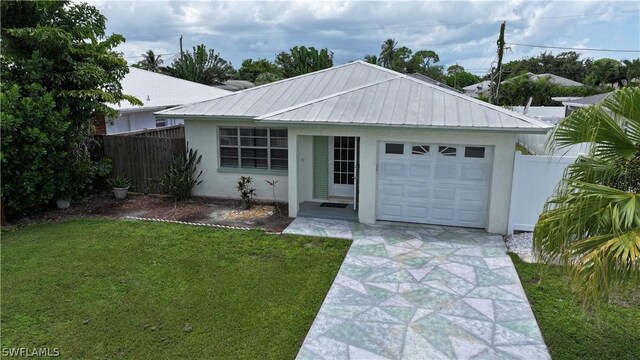 single story home featuring a garage and a front lawn