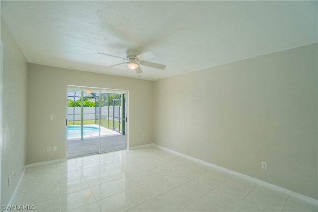 tiled empty room with ceiling fan