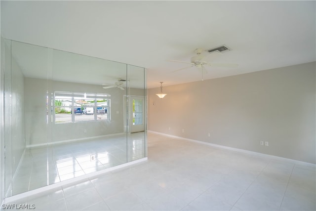 spare room with light tile patterned flooring and ceiling fan