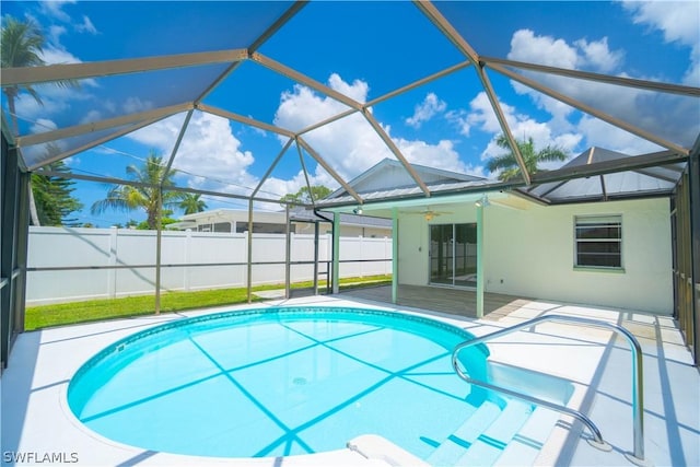 view of pool featuring ceiling fan, a patio area, and glass enclosure