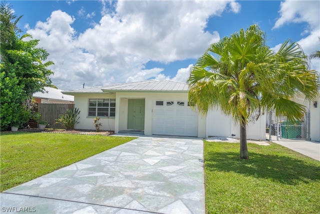 view of front of house with a garage and a front lawn