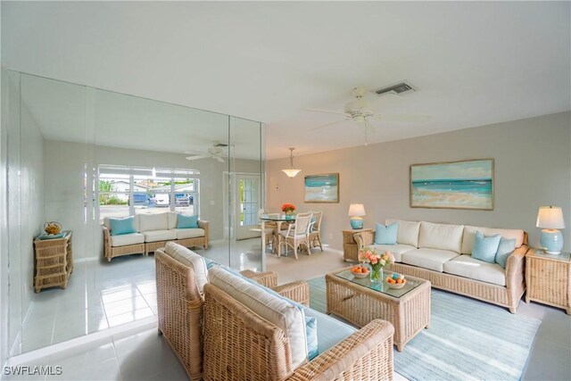 tiled living room featuring ceiling fan