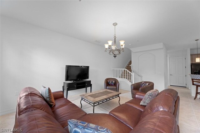 tiled living room featuring a notable chandelier