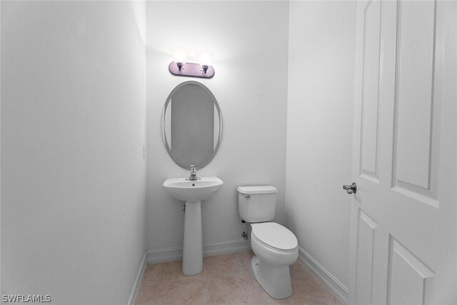 bathroom with toilet and tile patterned flooring