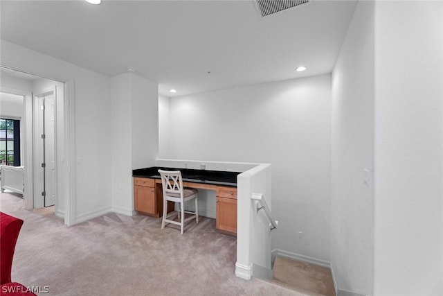 home office featuring recessed lighting, light colored carpet, visible vents, baseboards, and built in desk