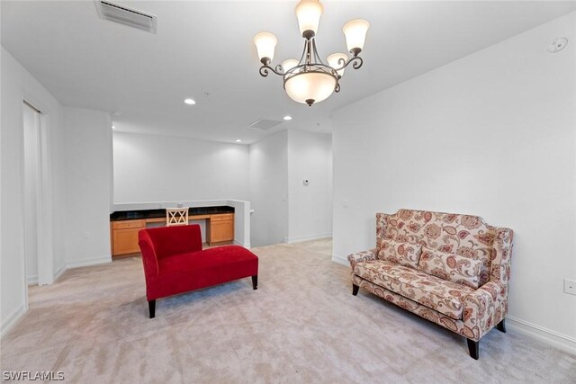 sitting room featuring a chandelier and light carpet