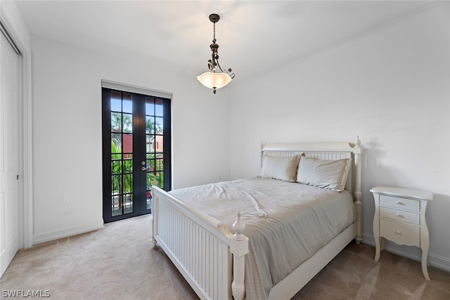 bedroom featuring access to outside, light carpet, and a closet