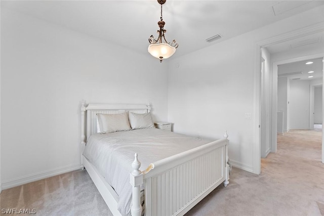 bedroom with light colored carpet, visible vents, and baseboards