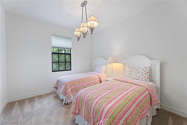 bedroom with baseboards, a chandelier, and light colored carpet