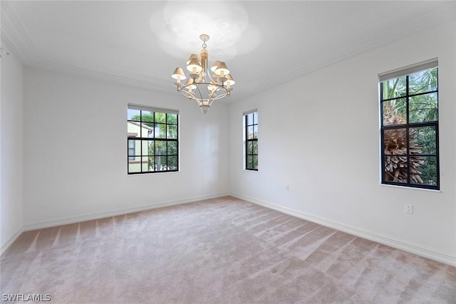 empty room featuring a healthy amount of sunlight, light carpet, a notable chandelier, and baseboards