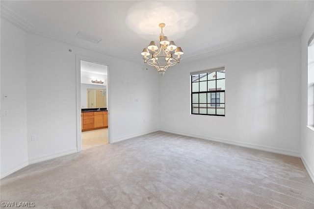 empty room with a chandelier, light carpet, crown molding, and baseboards