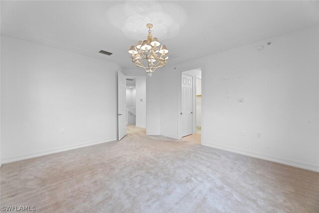 empty room featuring a notable chandelier, light carpet, and crown molding