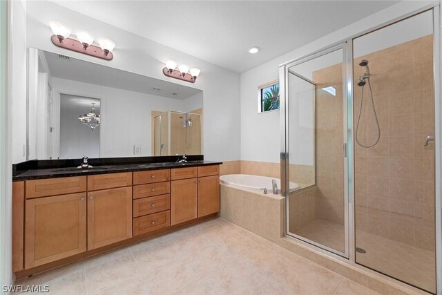 bathroom featuring shower with separate bathtub, tile patterned floors, and double sink vanity