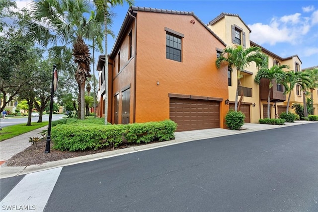 view of front of property with an attached garage and stucco siding