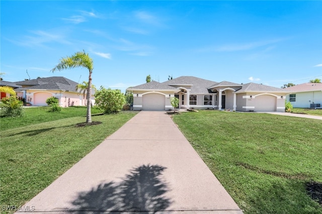 ranch-style house featuring cooling unit, a garage, and a front yard