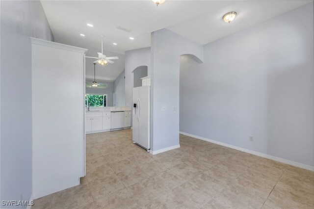 interior space with white appliances, ceiling fan, white cabinetry, and light tile patterned floors