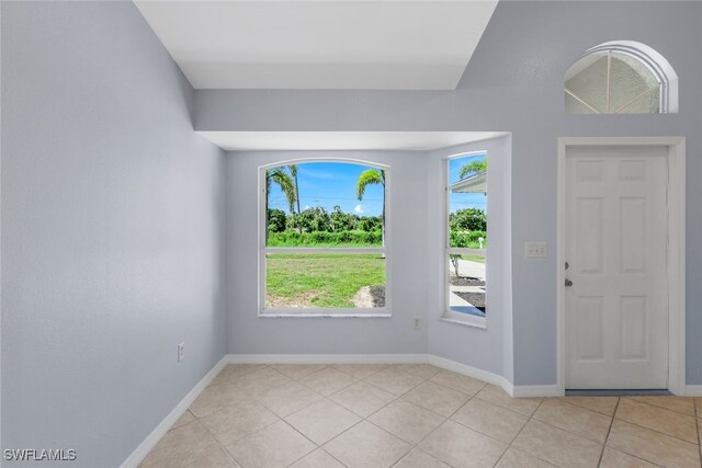 foyer entrance with plenty of natural light and light tile patterned floors