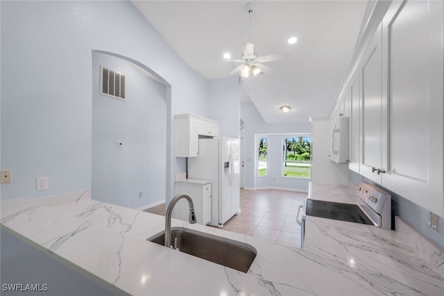 kitchen featuring sink, light stone countertops, white appliances, ceiling fan, and white cabinets