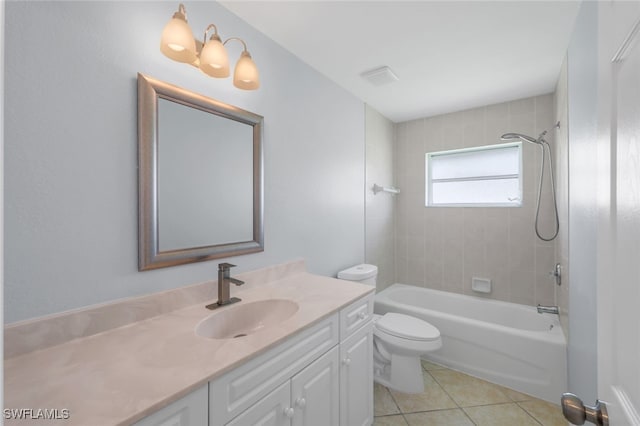 full bathroom with tile patterned flooring, toilet, tiled shower / bath, and vanity