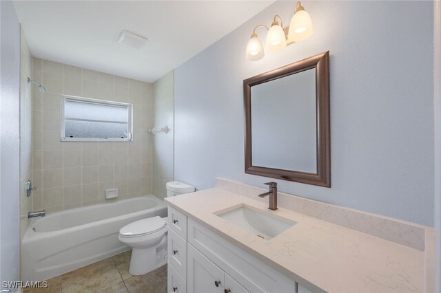 full bathroom with toilet, tiled shower / bath combo, vanity, and tile patterned floors