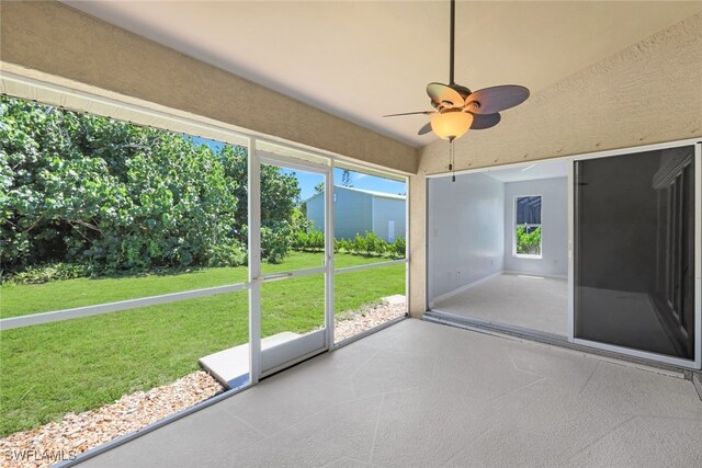 unfurnished sunroom with ceiling fan and a healthy amount of sunlight