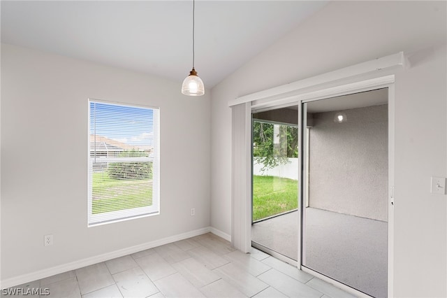 spare room featuring vaulted ceiling