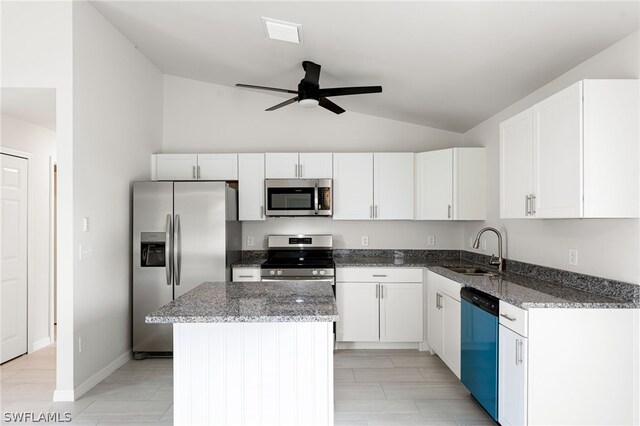 kitchen featuring sink, white cabinets, appliances with stainless steel finishes, and a center island