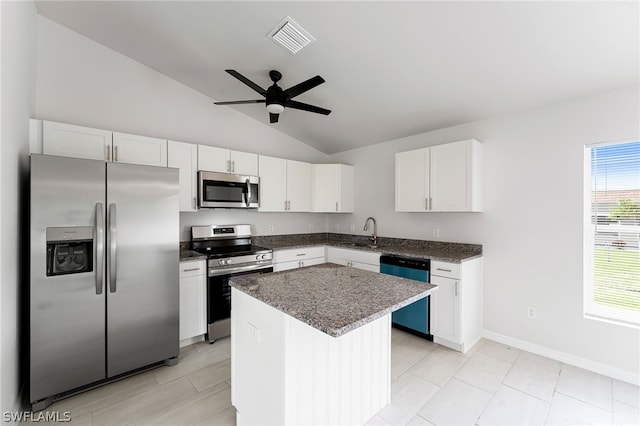 kitchen with white cabinets, a center island, stainless steel appliances, sink, and ceiling fan