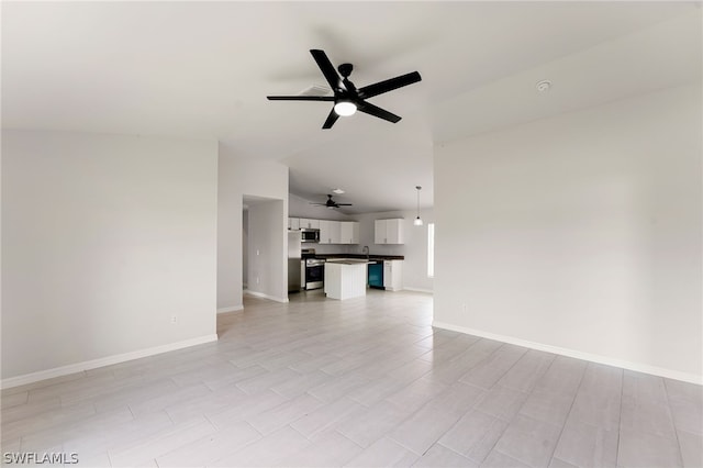 unfurnished living room with ceiling fan, lofted ceiling, and sink