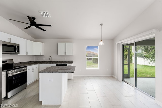 kitchen featuring stainless steel appliances, white cabinets, and a center island