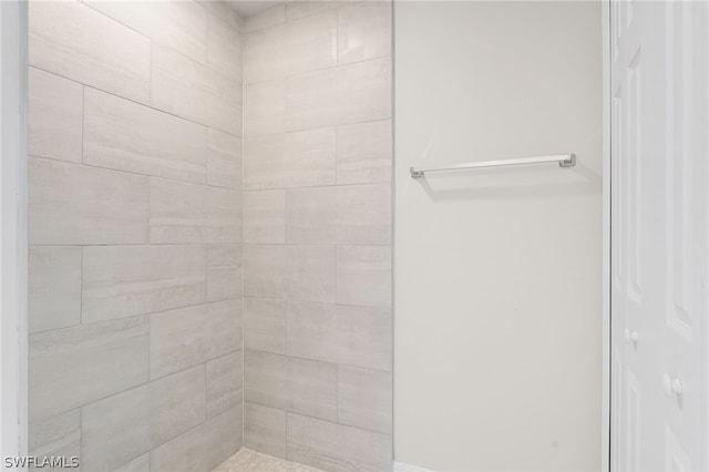 bathroom with a tile shower