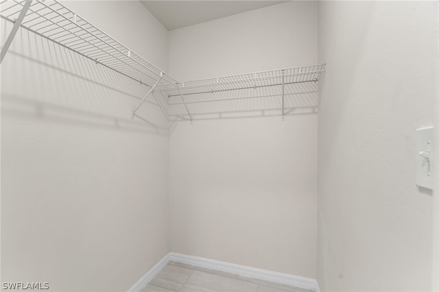 walk in closet featuring light tile patterned floors